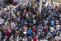 FILE - In this Aug. 31, 2021, file photo, motorcycle drivers wait to get fuel at a gas station in Beirut, Lebanon. Countries like Lebanon, Syria, Iraq, Lebanon and Yemen are all teetering on the brink of humanitarian catastrophe with an economic implosion that threatens to throw the region into even deeper turmoil. (AP Photo/ Hassan Ammar, File)