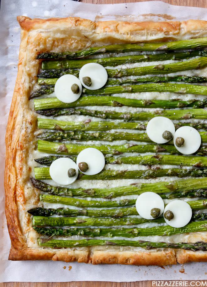 <p>Balance out all the Halloween candy you've been eating with some greens. No one will be mad about it once they see provolone and caper eyeballs.</p><p>Get the <strong><a href="http://pizzazzerie.com/holidays/monster-eye-asparagus-gruyere-tart/" rel="nofollow noopener" target="_blank" data-ylk="slk:Monster Eye Asparagus Gruyere Tart recipe;elm:context_link;itc:0;sec:content-canvas" class="link ">Monster Eye Asparagus Gruyere Tart recipe</a></strong> from Pizzazzerie. </p>