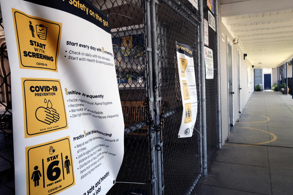 A chain-link fence lock is seen on a gate at a closed Ranchito Elementary School in the San Fernando Valley section of Los Angeles on Monday, July 13, 2020. Amid spiking coronavirus cases, Los Angeles Unified School District campuses will remain closed when classes resume in August, Superintendent Austin Beutner said Monday. (AP Photo/Richard Vogel)