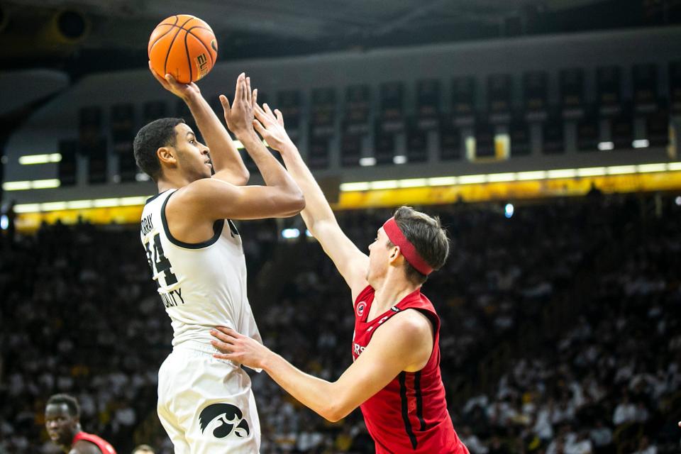Iowa forward Kris Murray (24) shoots a basket as Rutgers guard Paul Mulcahy defends during a NCAA Big Ten Conference men's basketball game, Sunday, Jan. 29, 2023, at Carver-Hawkeye Arena in Iowa City, Iowa.