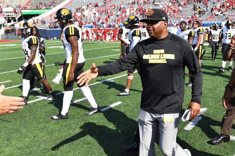 Pine Bluff coach Doc Gamble reaches out to shake hands with Arkansas coach Sam Pittman during an NCAA college football game Saturday, Oct. 23, 2021, in Little Rock, Ark. (AP Photo/Michael Woods)