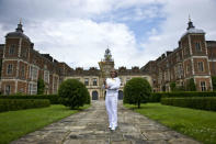 Torchbearer Alice Breheny carries the Olympic Flame through Hatfield Hall on the Torch Relay leg.