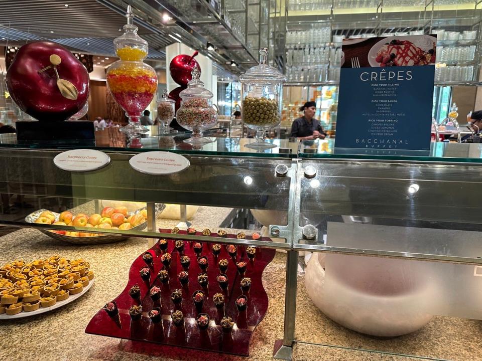 Crepe station at Bacchanal buffet with a small menu above miniature chocolate cones on display