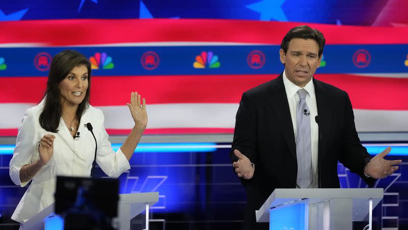 Former United Nations Ambassador Nikki Haley and Florida Gov. Ron DeSantis talk during a Republican presidential primary debate hosted by NBC News on Nov. 8, 2023, in Miami.