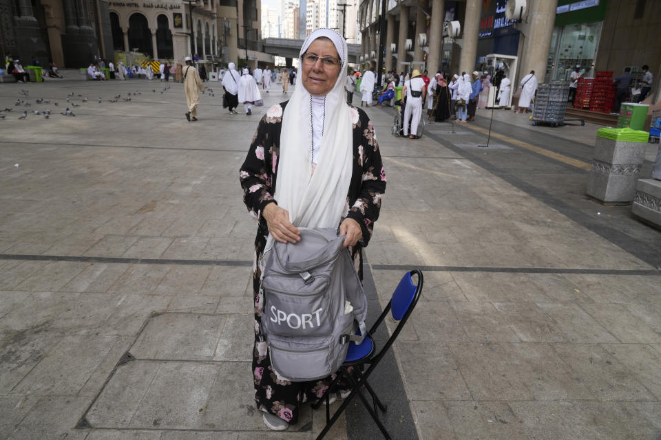 Egyptian pilgrim Umaima holds her bag outside the Grand Mosque during the annual Hajj pilgrimage in Mecca, Saudi Arabia, Saturday, June 24, 2023. Straw hats, cross-body bags, and collapsible chairs are some essentials pilgrims have on them as they perform the Hajj. The fifth pillar of Islam is a profoundly spiritual experience but requires practical and specific preparation to deal with hours of walking in scorching temperatures, camping stints, and massive crowds. (AP Photo/Amr Nabil)