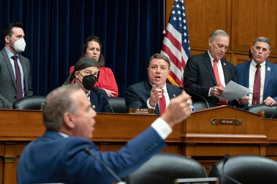 Committee Chair Pat Fallon, R-Texas, center, gets into an argument with Rep. David Cicilline, D-R.I., foreground, during the recess of the House Judiciary Subcommittee on Crime and Federal Government Surveillance and the House Oversight Subcommittee on Economic Growth, Energy Policy, and Regulatory Affairs joint hearing on Capitol Hill in Washington, Thursday, March 23, 2023. Others listening are Co-Chair Andy Biggs, R-Ariz., second from right, and ranking member Rep. Jamie Raskin, D-Md., second from left.