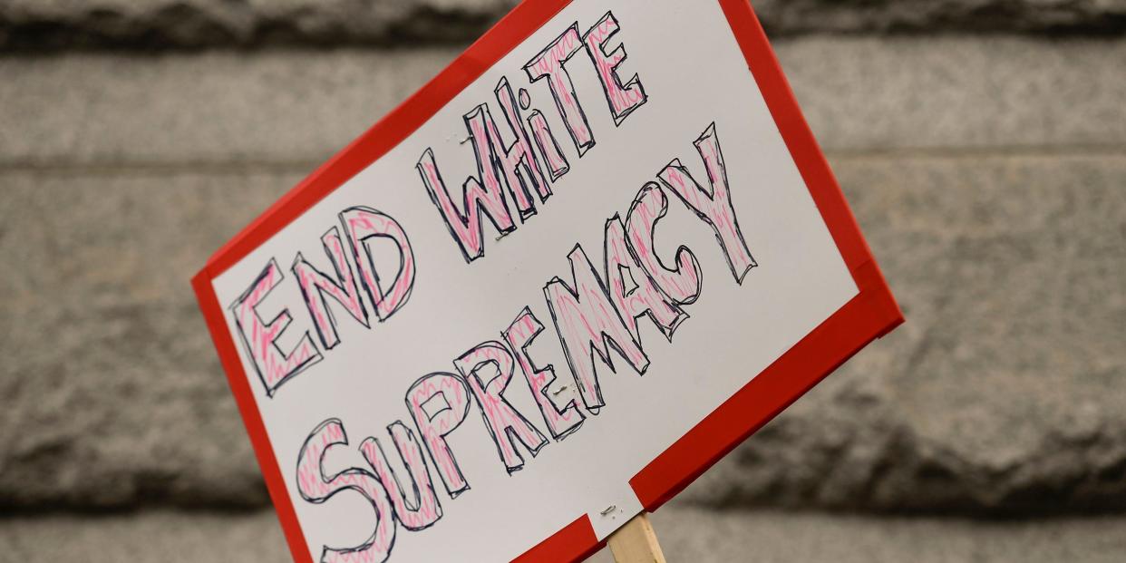 A protester holds a sign that reads "End White Supremacy" during the March Against White Supremacy going from Reading City Park to the Christopher Columbus Statue in the park, to Reading City Hall, and then to the Berks County Services Center Wednesday afternoon July 8, 2020.