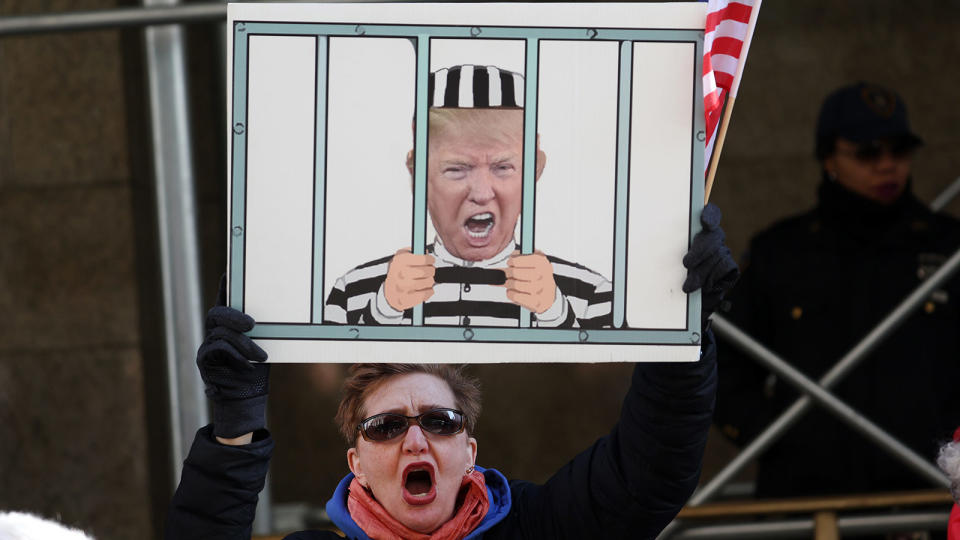 <b>Demonstrators gather outside of Manhattan Criminal Court March 21, 2023, as the Manhattan district attorney decides whether to charge former U.S. President Donald Trump.</b> Scott Olson/Getty Images