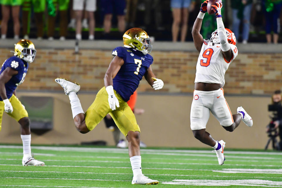 SOUTH BEND, INDIANA - NOVEMBER 07: Running back Travis Etienne #9 of the Clemson Tigers catches a pass as defensive lineman Isaiah Foskey #7 of the Notre Dame Fighting Irish defends in the third quarter at Notre Dame Stadium on November 7, 2020 in South Bend, Indiana. (Photo by Matt Cashore-Pool/Getty Images)