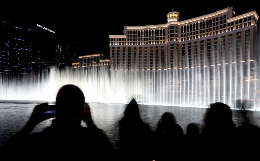 LAS VEGAS, NEV. - MAY 16, 2022. Visitors take in the free water show at the Bellagio Hotel and Casino on the Las vegas Strip. The water in the fountain reportedly comes from a groundwater source that was once used to irrigate another resort. Lake Bellagio containes about 22 million gallons of water, and is one of the most photographed places in the world. Lake Mead's water level is currently 62 feet below the level in 2000, the last time it was last considered full. (Luis Sinco / Los Angeles Times)