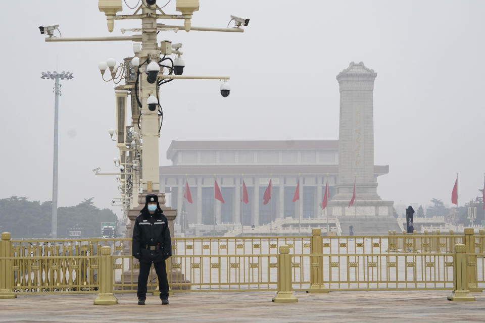 A Chinese police officer guards an empty Tiananmen Square near the Great Hall of the People in Beijing on Wednesday, March 3, 2021. In a sign of confidence China has reverted back to holding its annual Congress meetings to march this year after delaying them due to the outbreak of the coronavirus last year. As usual, security has been tightened in the capital with paramilitary troops patrolling near the Great Hall of the People where the meetings are held and standing guard at subway stations. (AP Photo/Ng Han Guan)