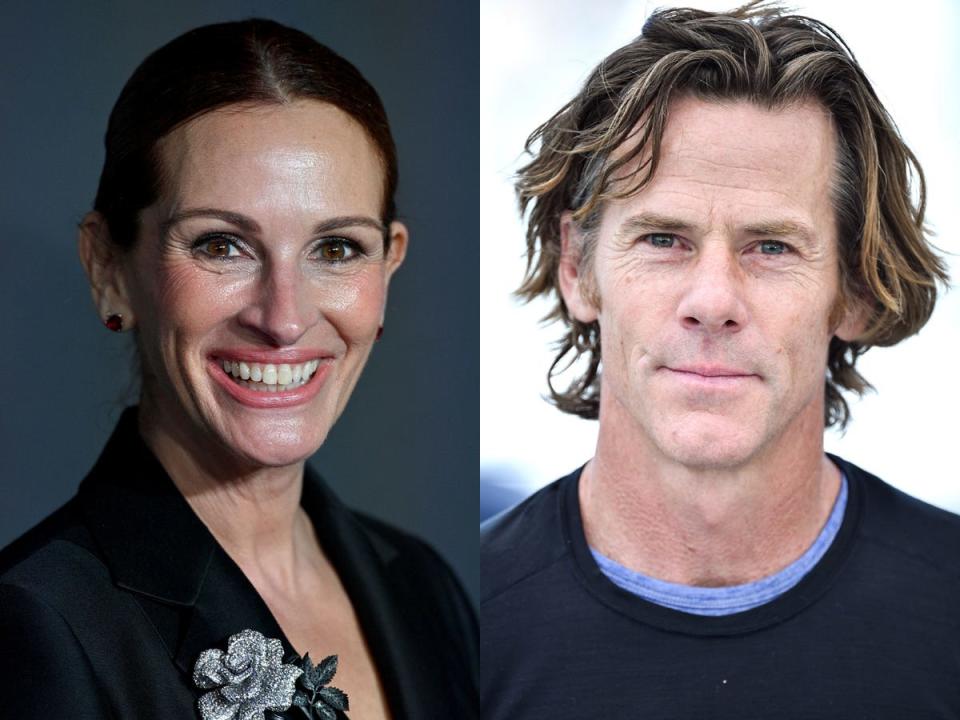 A side-by-side image of a smiling Julia Roberts with slicked back hair, and Danny Moder, wearing a dark shirt and looking straight at the camera.