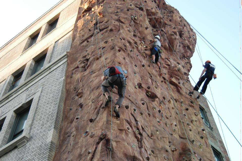 This 2012 photo supplied by Outward Bound shows climbers on a five-story climbing wall on the side of the organization’s New York City headquarters in Long Island City, a neighborhood in the borough of Queens. Long Island City is experiencing a hotel boom that’s attracting tourists, and the climbing wall is one of a number of things to do in the area, which, along with the adjacent neighborhood of Astoria , offers waterfront parks, museums, and good restaurants.(AP Photo/Outward Bound, Jeff Grinnell)