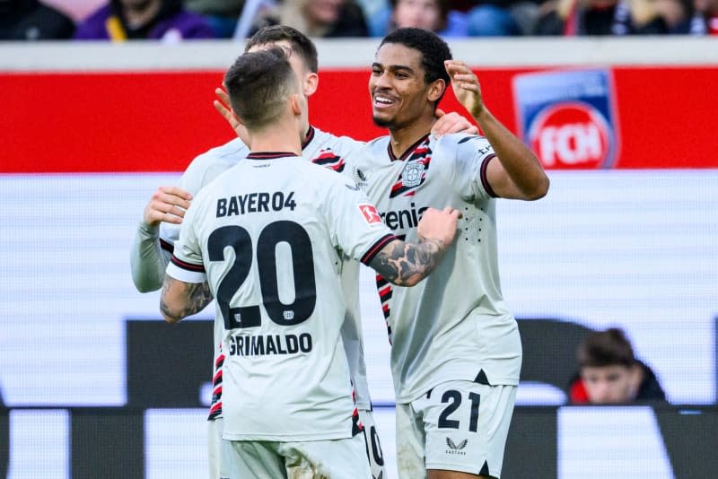 Leverkusen's Amine Adli (R) celebrates scoring his side's second goal with teammate Alex Grimaldo during the German Bundesliga soccer match between 1. FC Heidenheim and Bayer Leverkusen at the Voith-Arena. Tom Weller/dpa