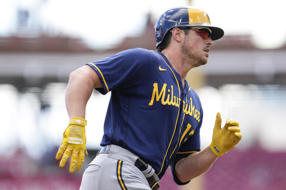 Milwaukee Brewers' Hunter Renfroe (12) rounds third base after hitting a solo home run during the second inning of a baseball game against the Cincinnati Reds Sunday, Sept. 25, 2022, in Cincinnati. (AP Photo/Jeff Dean)