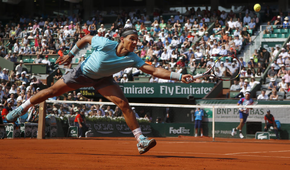 FILE - Spain's Rafael Nadal returns the ball during the third round match of the French Open tennis tournament against Argentina's Leonardo Mayer at the Roland Garros stadium, in Paris, France, Saturday, May 31, 2014, as he has announced he will retire from tennis at age 38 following the Davis Cup finals in November. (AP Photo/Michel Euler, File)