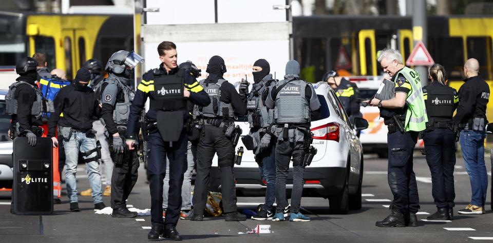 Police forces stand near a tram at the 24 Oktoberplace in Utrecht, on March 18, 2019 where a shooting took place.  A gunman who opened fire on a tram in the Dutch city of Utrecht on March 18, injuring several people, is on the run, police said.