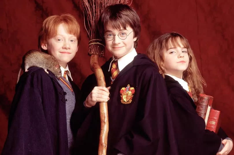 Harry Potter and the Philosopher's Stone November 2001 (L-R) Ron Weasley, played by Rupert Grint,  Harry Potter played by Daniel Radcliffe, and Hermione Grainger, played by Emma Watson