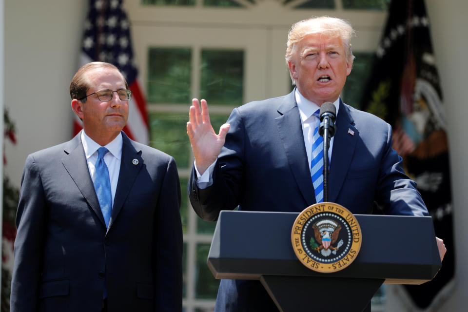 Secretary of Health and Human Services Alex Azar looks on as President Donald Trump speaks during an event about prescription drug prices in the Rose Garden of the White House, Friday, May 11, 2018, in Washington. (AP Photo/Evan Vucci)