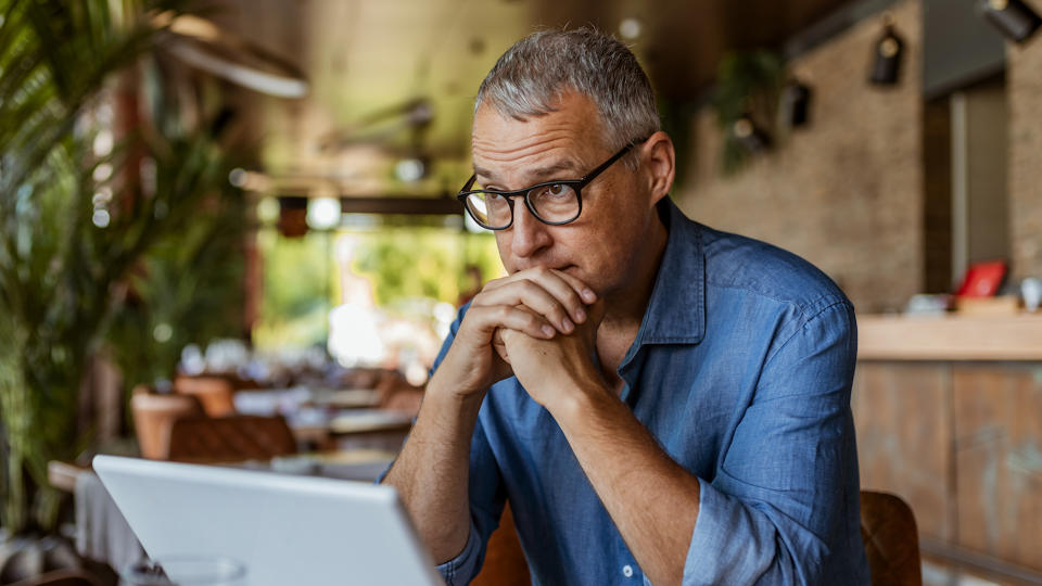 Contemplating businessman in the restaurant feeling sad.