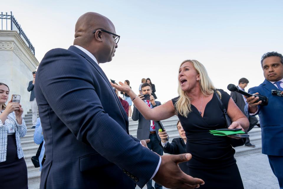 Rep. Jamaal Bowman, D-N.Y., left, and Rep. Marjorie Taylor Greene, R-Ga., argue on the steps of the Capitol after Bowman shouted down Rep. George Santos, R-N.Y., who was speaking to reporters following an effort to expel him from the House in Washington on Wednesday.