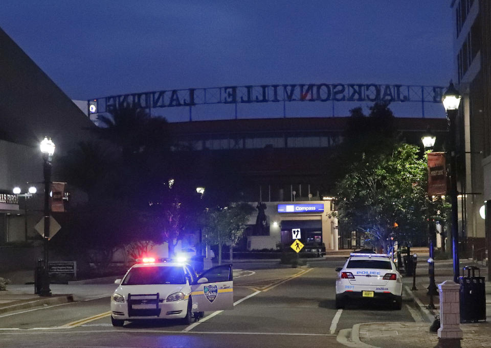 <p>Police cars block off a street near the scene of a mass shooting at Jacksonville Landing in Jacksonville, Fla., Aug. 26, 2018. Florida authorities are reporting multiple fatalities at the riverfront mall that was hosting a video game tournament on Aug. 26, 2018, in Jacksonville, Fla. (Photo: John Raoux/AP) </p>