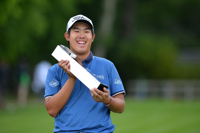South Korea's Byeong-hun An celebrates with the trophy after winning the PGA Championship at Wentworth Golf Club in Surrey, south-west of London, on May 24, 2015