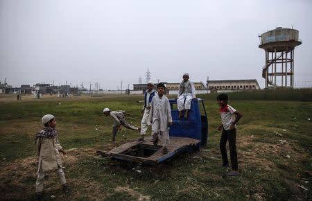 Children play on a field next to the abandoned former Union Carbide pesticide plant in Bhopal November 15, 2014. REUTERS/Danish Siddiqui