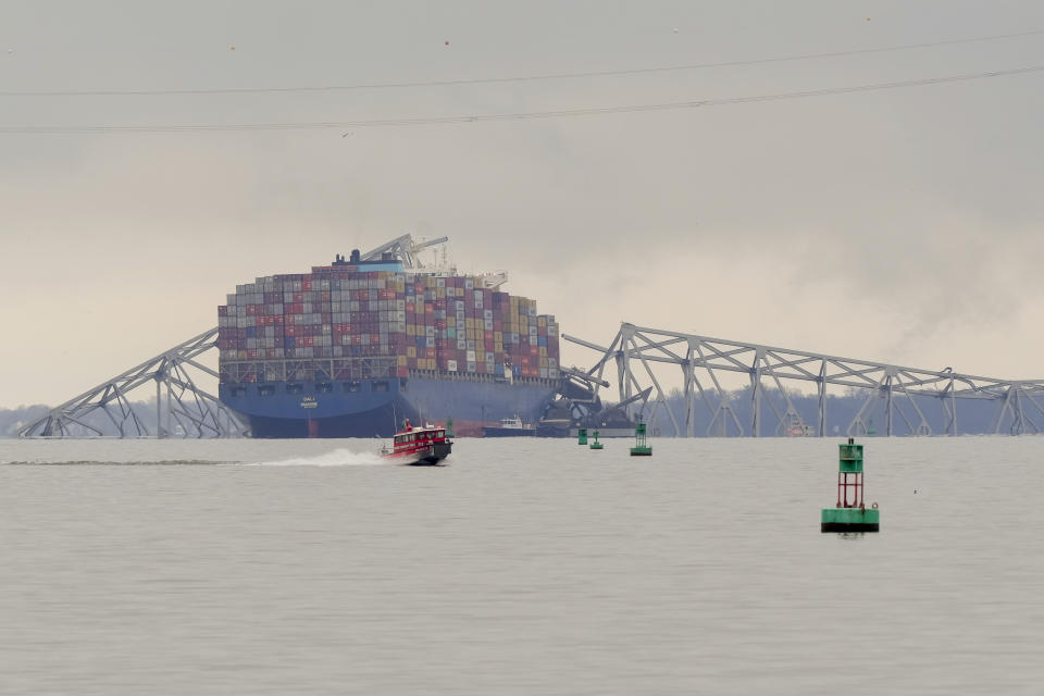 A container ship rests against wreckage of the Francis Scott Key Bridge on Wednesday, March 27, 2024, in Baltimore. The ship rammed into the major bridge early Tuesday, causing it to collapse in a matter of seconds and creating a terrifying scene as several vehicles plunged into the chilly river below. (AP Photo/Matt Rourke)