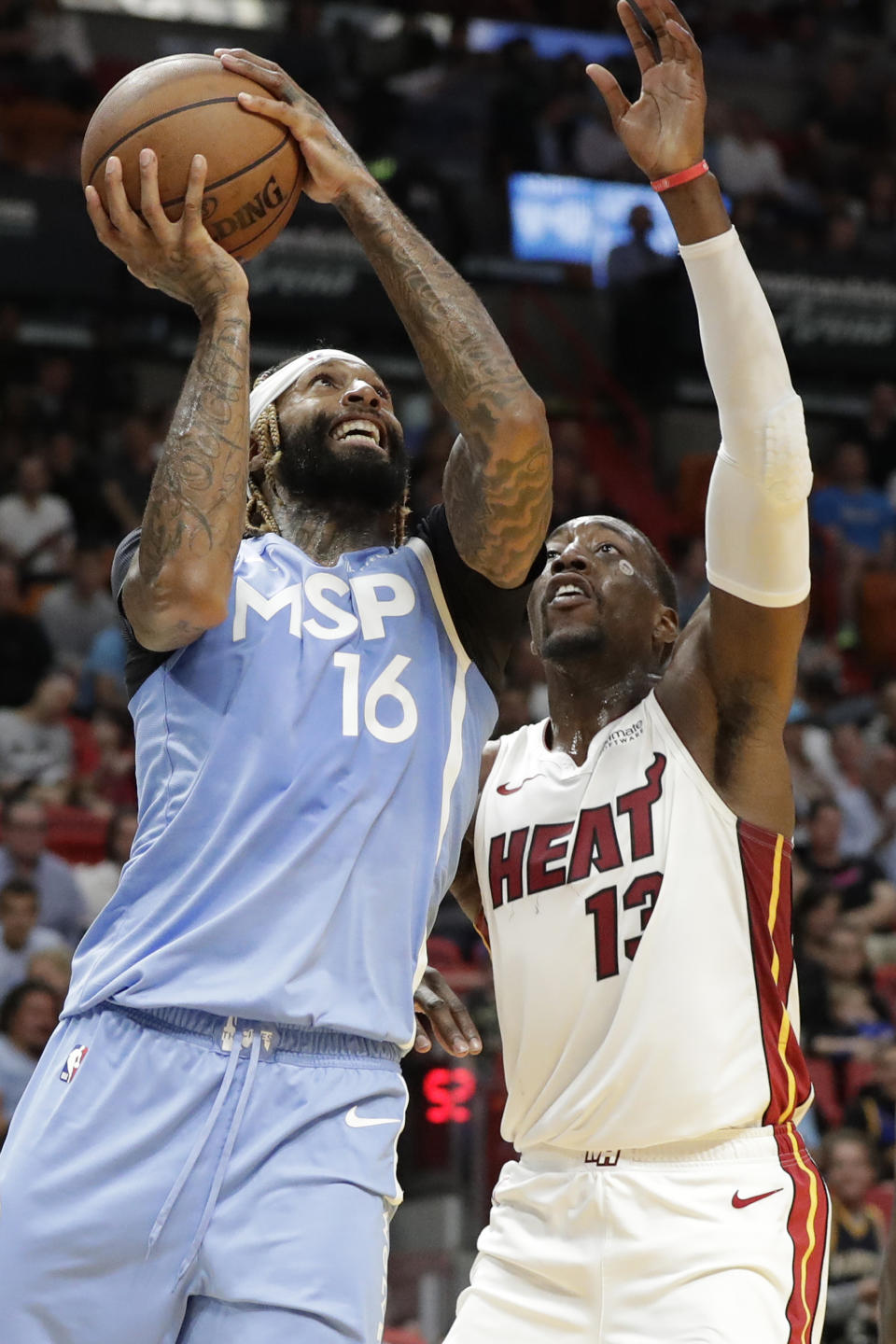 Minnesota Timberwolves forward James Johnson (16) goes up for a shot against Miami Heat forward Bam Adebayo (13) during the first half of an NBA basketball game, Wednesday, Feb. 26, 2020, in Miami. (AP Photo/Wilfredo Lee)