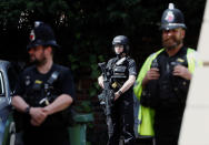<p>Armed and uniformed police officers stand outside a residential property near to where a man was arrested in the Chorlton area of Manchester, Britain on May 23, 2017. (Stefan Wermuth/Reuters) </p>