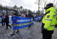 Doctors march toward the presidential office during a rally against the government's medical policy in Seoul, South Korea, Sunday, Feb. 25, 2024. The South Korean government on Wednesday warned thousands of striking doctors to return to work immediately or face legal action after their collective walkouts caused cancellations of surgeries and disrupted other hospital operations. (AP Photo/Ahn Young-joon)