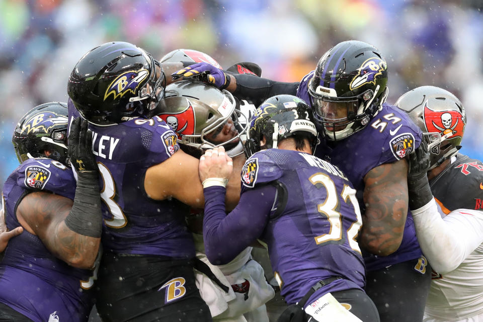 <p>Running back Peyton Barber #25 of the Tampa Bay Buccaneers is tackled is the Baltimore Ravens defense in the first half at M&T Bank Stadium on December 16, 2018 in Baltimore, Maryland. (Photo by Rob Carr/Getty Images) </p>