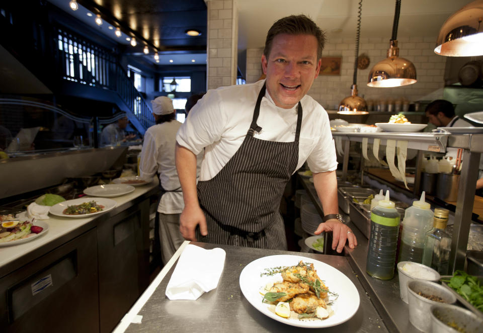 In this photo taken Monday, Oct. 29, 2012, chef Tyler Florence prepares a dish of fried chicken in the kitchen at his Wayfare Tavern in San Francisco. Baby food and fried chicken may well be the legacy for which Tyler Florence ultimately is best known. Which seems a bit crazy given his near ubiquity on the Food Network since its earliest days on air, his years of running the celebrity chef gauntlet, his many cookbooks, product lines and appearances. (AP Photo/Eric Risberg)