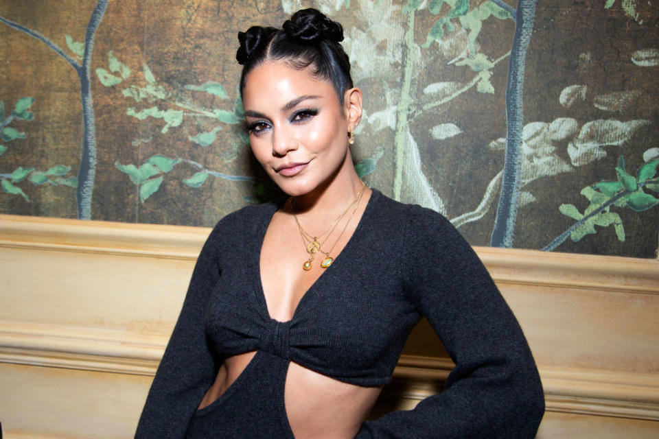 Close-up of Vanessa in a long-sleeved, deep-V cutout outfit