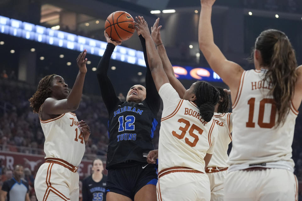 BYU forward Lauren Gustin (12) shoots against Texas forwards Amina Muhammad (14) and Madison Booker (35) during the first half of an NCAA college basketball game in Austin, Texas, Saturday, March 2, 2024. (AP Photo/Eric Gay)