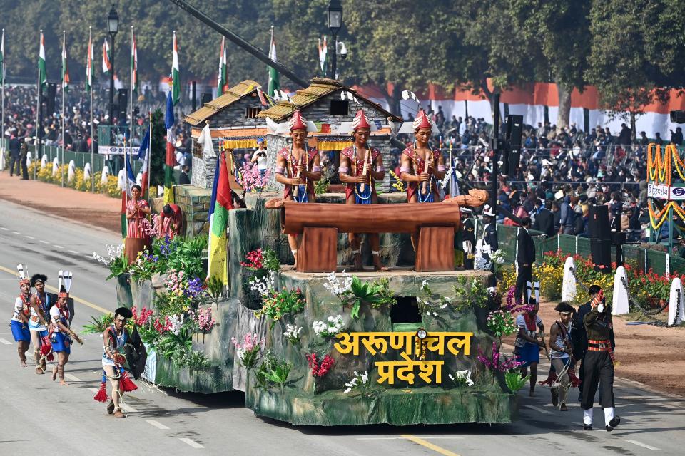 Performers dance next to a float representing Arunachal Pradesh state on Rajpath during the Republic Day parade in New Delhi on January 26, 2021. (Photo by Jewel SAMAD / AFP) (Photo by JEWEL SAMAD/AFP via Getty Images)