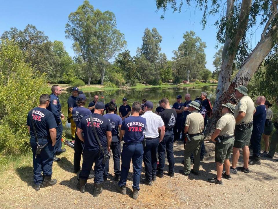 Fresno Fire and Fresno County Sheriff’s Office personnel gather Saturday, July 30, 2022, at the Fort Washington Beach campground where rescuers searched the waters for two missing people.