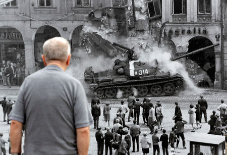 A man looks at a picture, commemorating the 50th anniversary of the Soviet-led invasion into former Czechoslovakia, placed on a street in Liberec, Czech Republic, August 21, 2018. REUTERS/David W Cerny