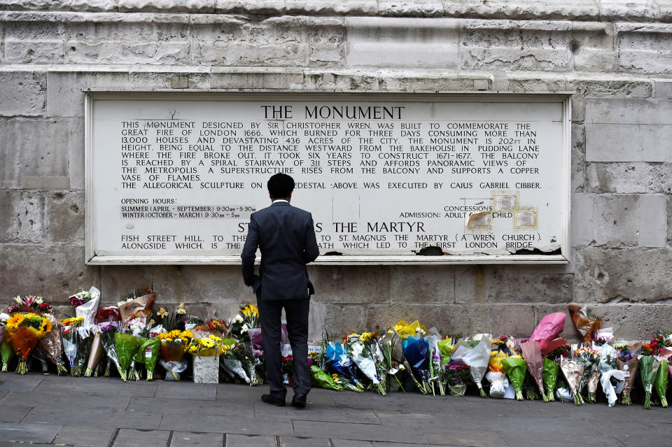 <p>A man observes flowers left along the base of the Monument to the Great Fire of London near London Bridge after an attack on the bridge and nearby Borough Market left 7 dead and dozens injured, in London, Britain, June 5, 2017. (Photo: Clodagh Kilcoyne/Reuters) </p>