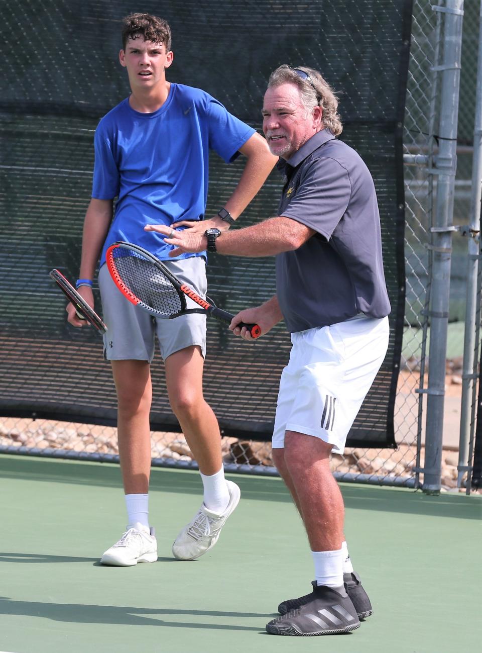 Bentwood Country Club's Kevin Collins gives a tennis lesson to Wall High School's Payne Smith in a file photo.