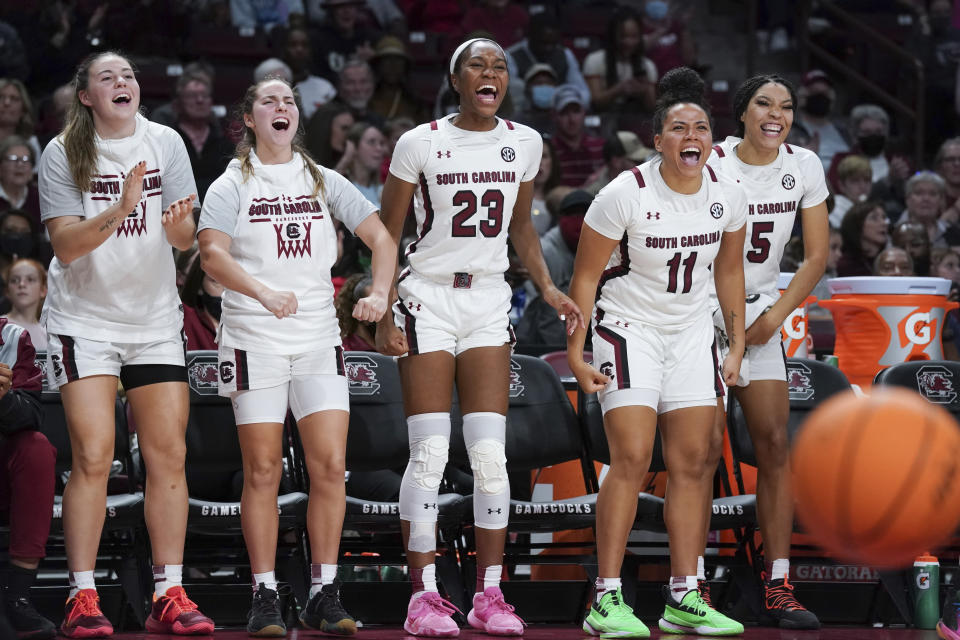 South Carolina forward Elysa Wesolek, left, Olivia Thompson, Bree Hall (23), Destiny Littleton (11) and Victaria Saxton (5) celebrate a score during the second half of an NCAA college basketball game against Elon Friday, Nov. 26, 2021, in Columbia, S.C. (AP Photo/Sean Rayford)