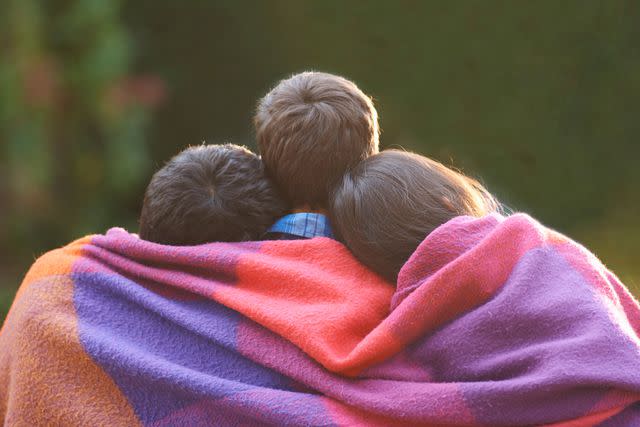 <p>Getty</p> Three people in a relationship (stock image)