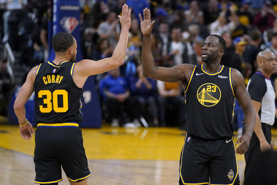 Golden State Warriors guard Stephen Curry (30) celebrates with forward Draymond Green (23) during the second half of Game 3 of the team's NBA basketball Western Conference playoff semifinal against the Memphis Grizzlies in San Francisco, Saturday, May 7, 2022. (AP Photo/Jeff Chiu)