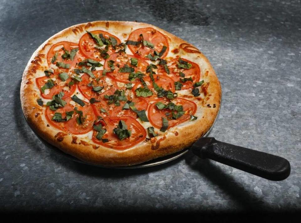 Margherita pizza with fresh basil, thinly sliced tomatoes and garlic is a popular menu item at Gino’s Pizza, which has locations in Pismo Beach and San Luis Obispo.