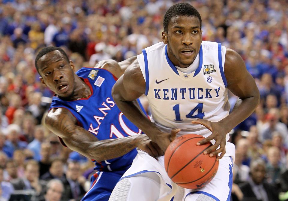 Michael Kidd-Gilchrist battles with Tyshawn Taylor in the first half.April 2, 2012