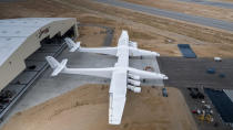 FILE- In this May 31, 2017 photo provided by Stratolaunch Systems Corp., the newly built Stratolaunch aircraft is moved out of its hangar for the first time in Mojave, Calif. Prior to his death on Monday, Oct. 15, 2018, Paul Allen invested large sums in technology ventures, research projects and philanthropies, some of them eclectic and highly speculative. Outside of bland assurances from his investment company, no one seems quite sure what happens now. One of Allen’s more esoteric ventures is Stratolaunch, which is building an enormous twin-fuselage jet aircraft designed to launch satellites from high altitudes. (Stratolaunch Systems Corp. via AP)