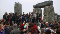 Crowds gather at dawn amongst the stones at Stonehenge in Wiltshire for the Summer Solstice.