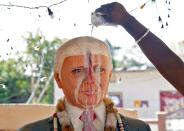 Bussa Krishna, a fan of US President Donald Trump, offers prayers to a statue of Trump at his house in Konney village