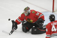 Chicago Blackhawks goalie Petr Mrazek (34) makes a save during the first period of an NHL hockey game against the Calgary Flames Tuesday, March 26, 2024, in Chicago. (AP Photo/Paul Beaty)